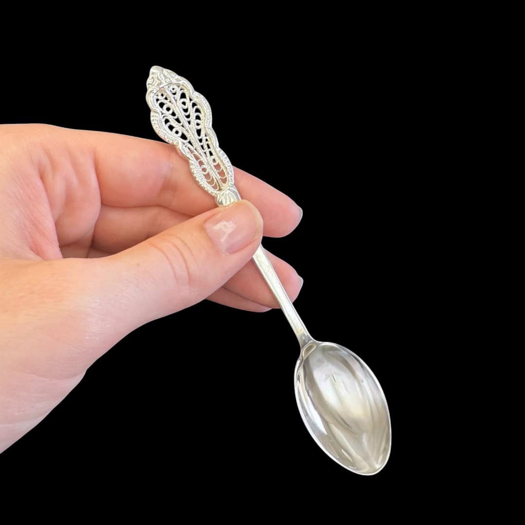 Handmade silver filigree christening teaspoon with an ornate scrolled openwork handle, by Lefkara Silver Cyprus.