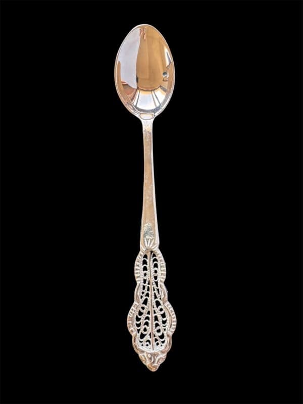 Handmade silver filigree christening teaspoon with an ornate scrolled openwork handle, by Lefkara Silver Cyprus.