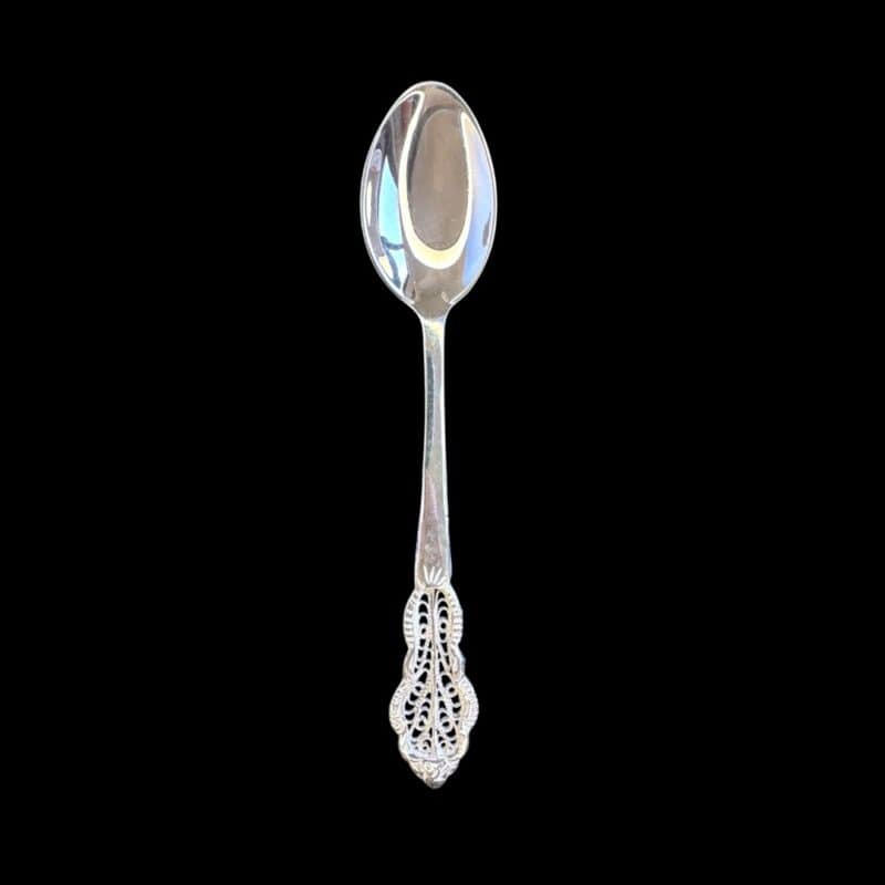 Handmade silver filigree christening teaspoon with an ornate scrolled openwork handle, by Lefkara Silver Cyprus.