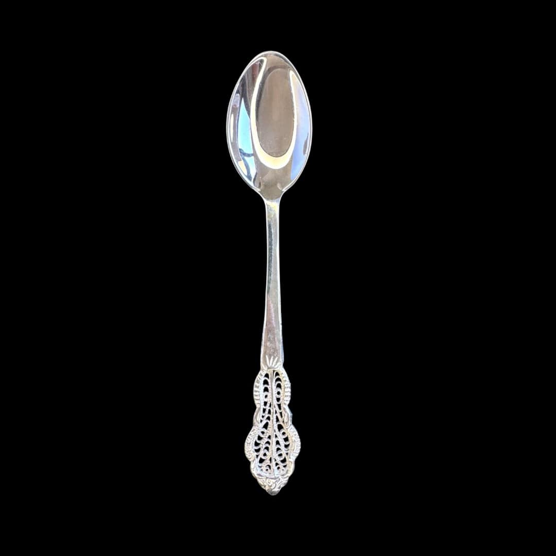 Handmade silver filigree christening teaspoon with an ornate scrolled openwork handle, by Lefkara Silver Cyprus.