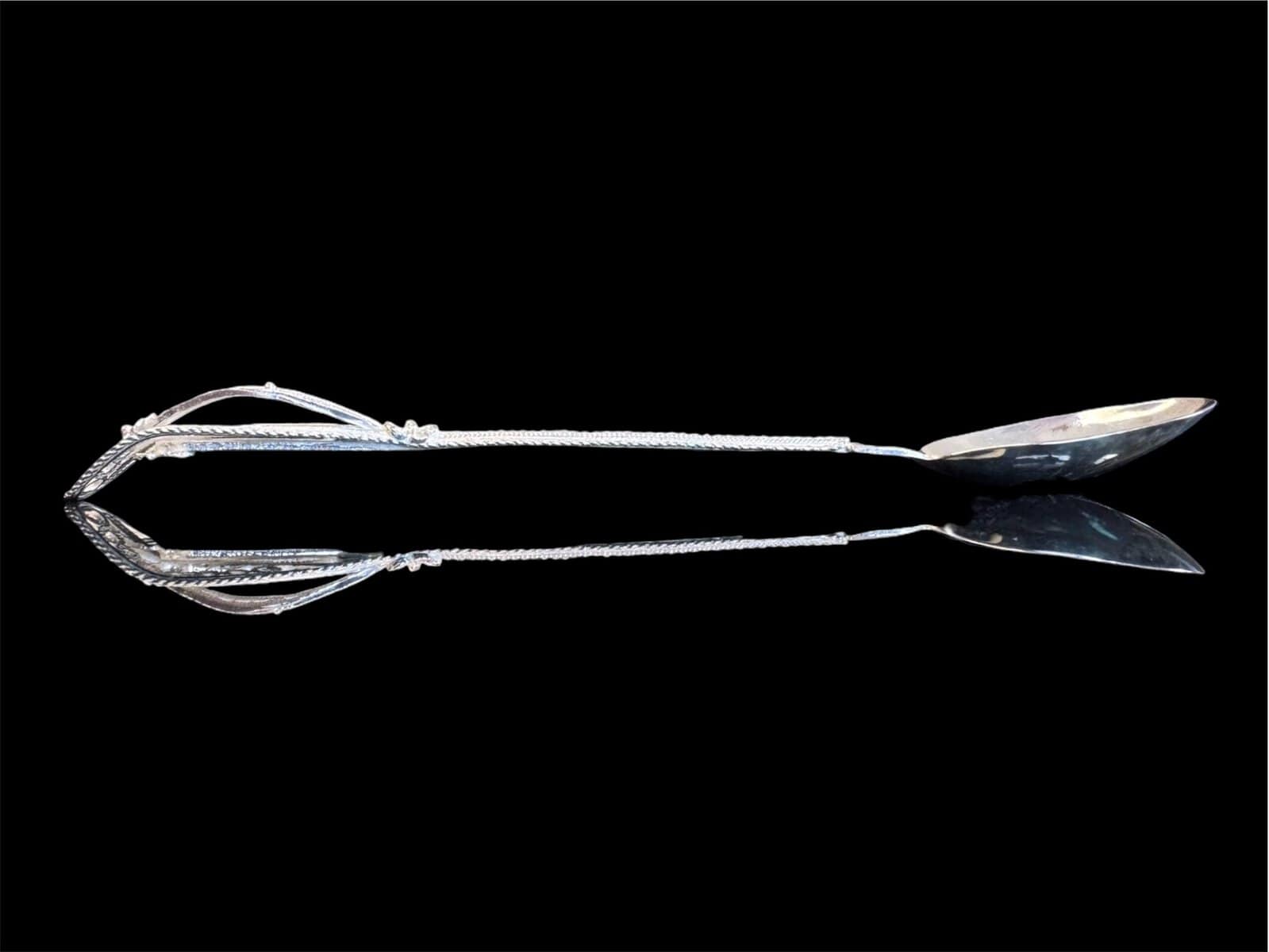 Handmade silver filigree spoon with a twisted stem and teardrop openwork handle, by Lefkara Silver Cyprus.