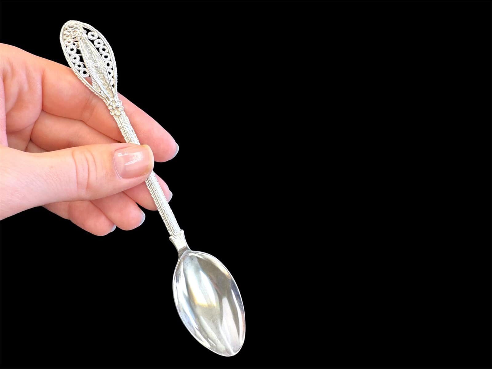 Handmade silver filigree spoon with a twisted stem and teardrop openwork handle, by Lefkara Silver Cyprus.