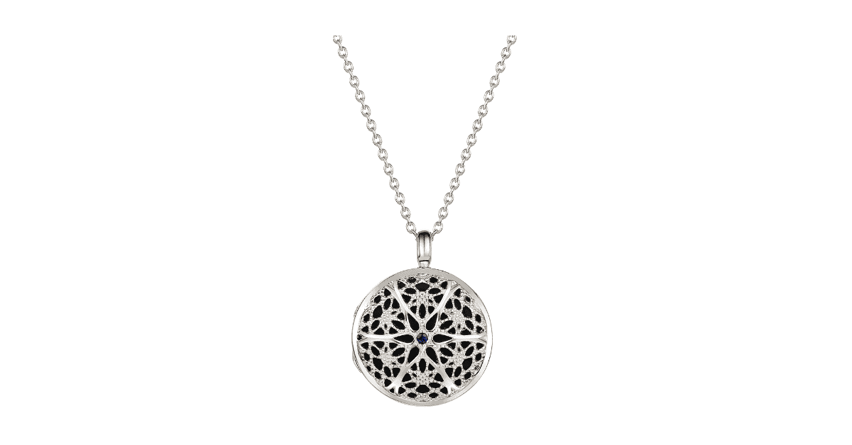 A silver filigree locket.