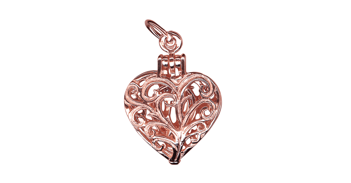 A rose gold silver filigree locket.