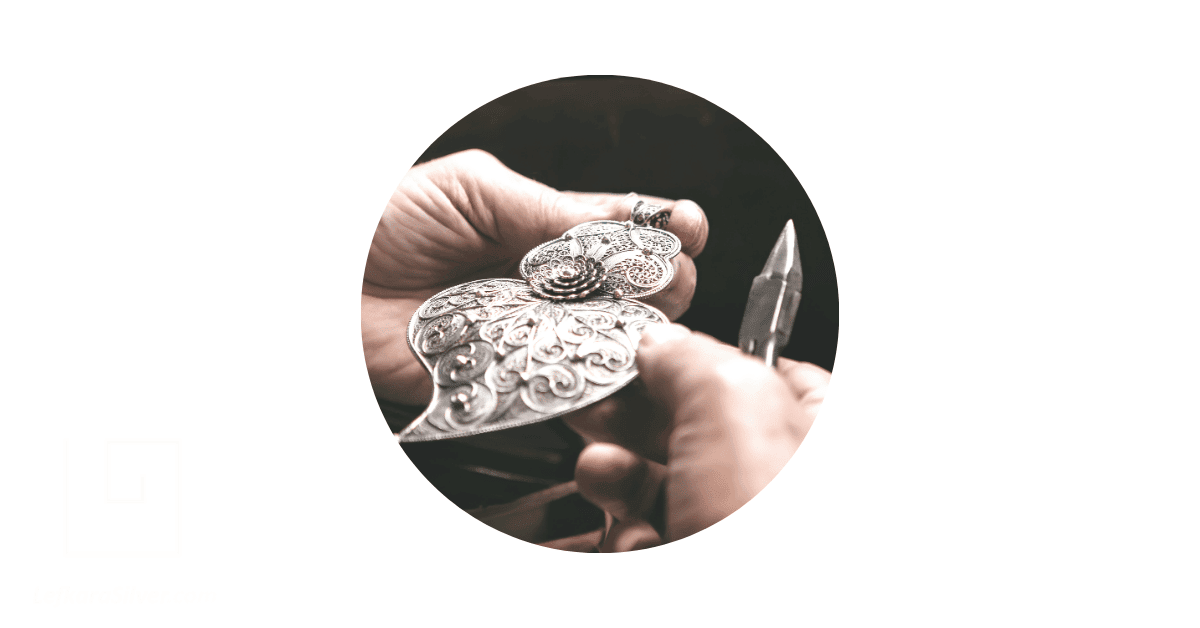 An artisan's hands making a viana heart Portuguese filigree jewelry