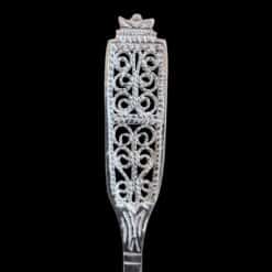 Handmade silver baby feeding spoon with an elongated bowl and lacelike filigree handle, by Lefkara Silver Cyprus.