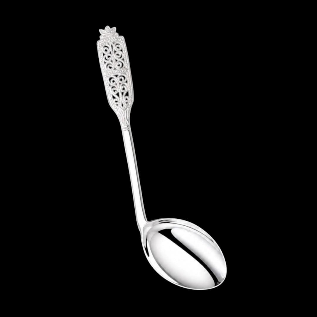 Handmade silver baby feeding spoon with an elongated bowl and lacelike filigree handle, by Lefkara Silver Cyprus.