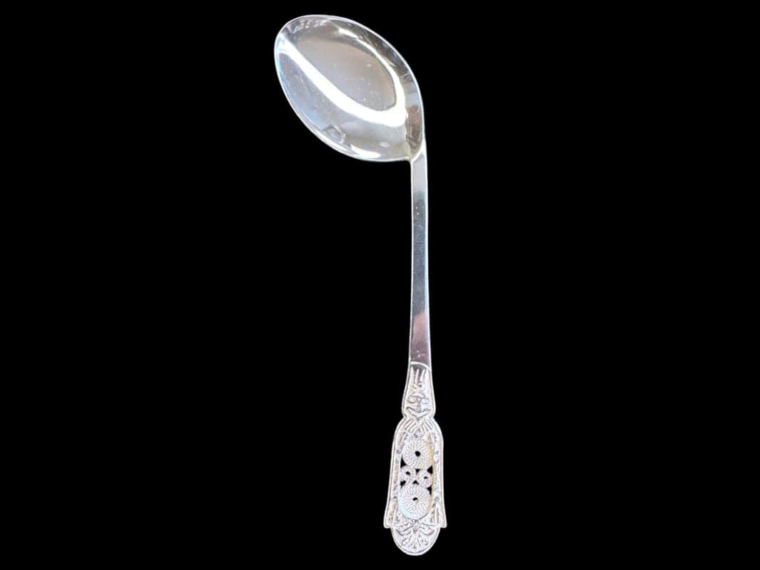 Handmade silver baby feeding spoon with an engraved pierced medallion handle, by Lefkara Silver Cyprus.