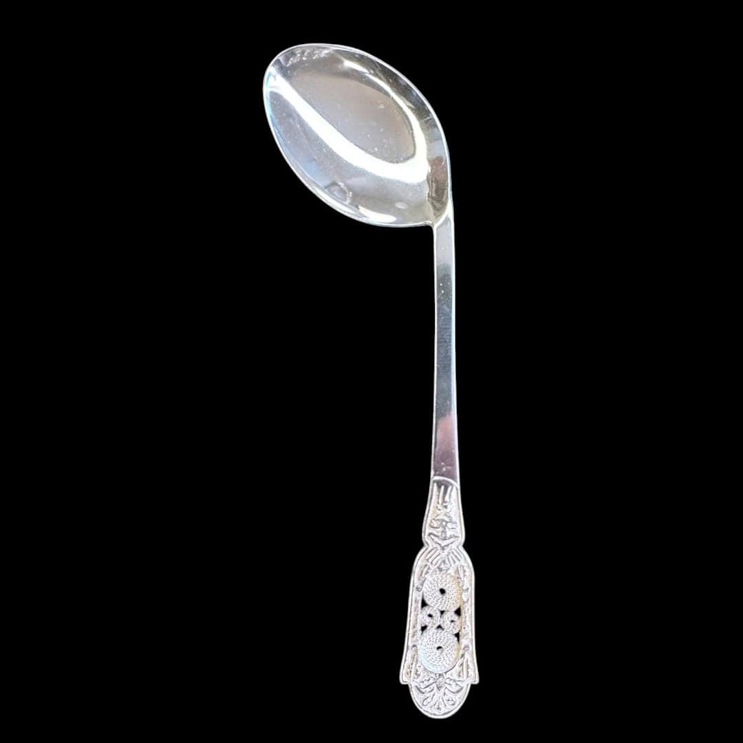 Handmade silver baby feeding spoon with an engraved pierced medallion handle, by Lefkara Silver Cyprus.