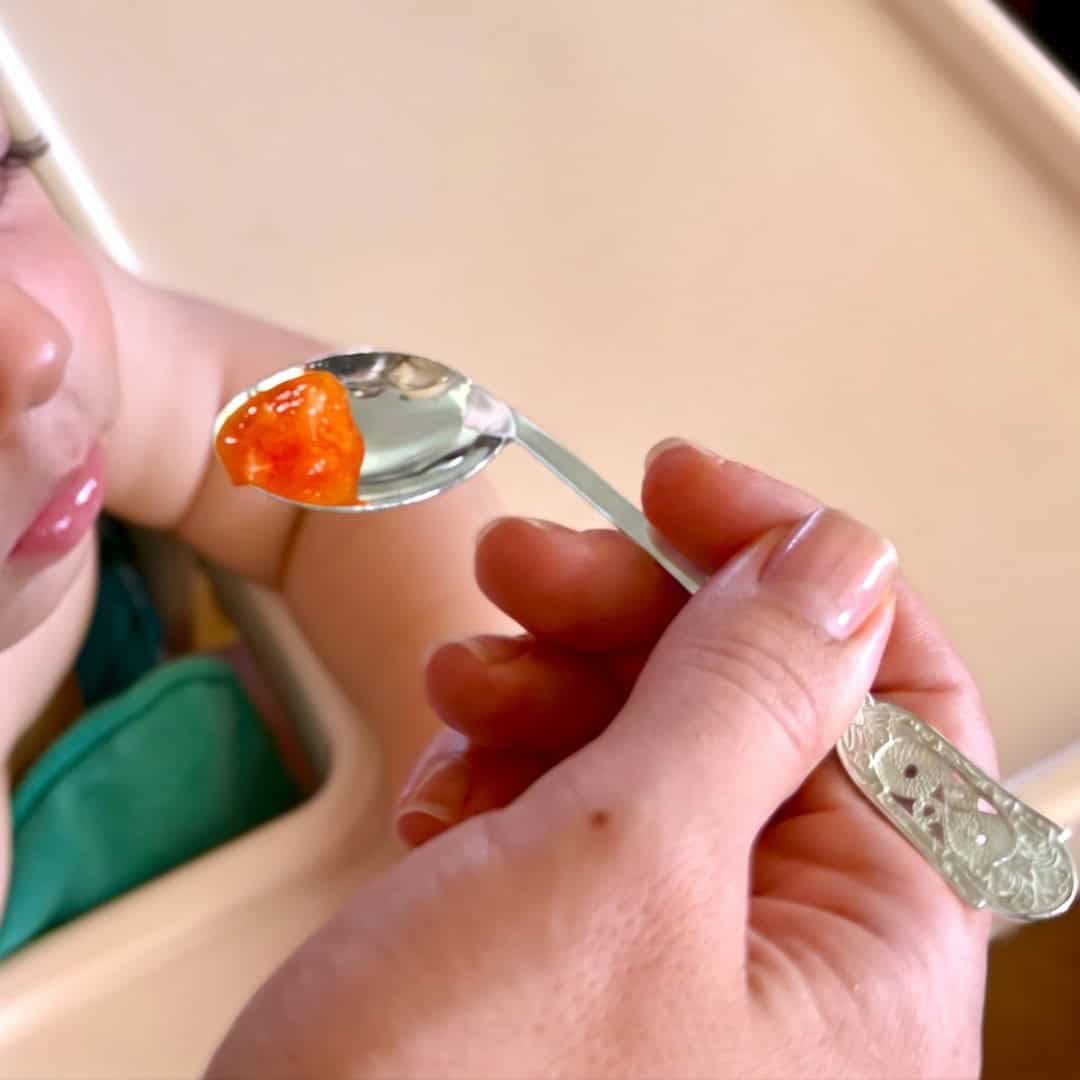 Handmade silver baby feeding spoon with an engraved pierced medallion handle, by Lefkara Silver Cyprus.