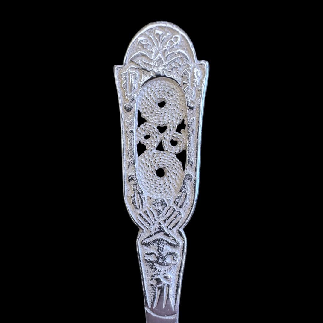 Handmade silver baby feeding spoon with an engraved pierced medallion handle, by Lefkara Silver Cyprus.